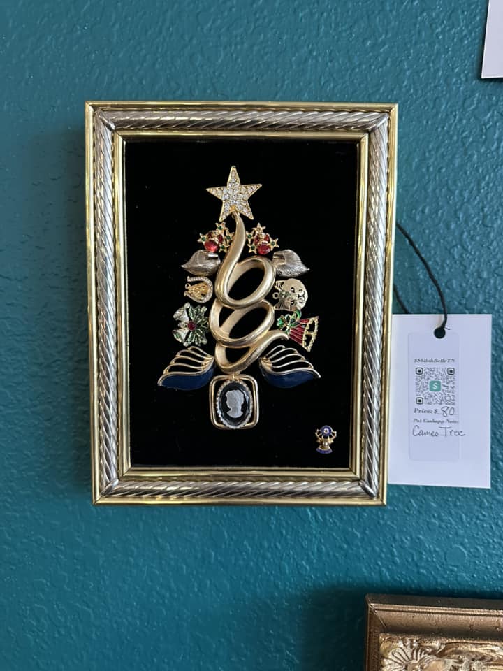 Christmas tree art piece made of vintage jewelry on velvet, framed in a silver and golden frame
