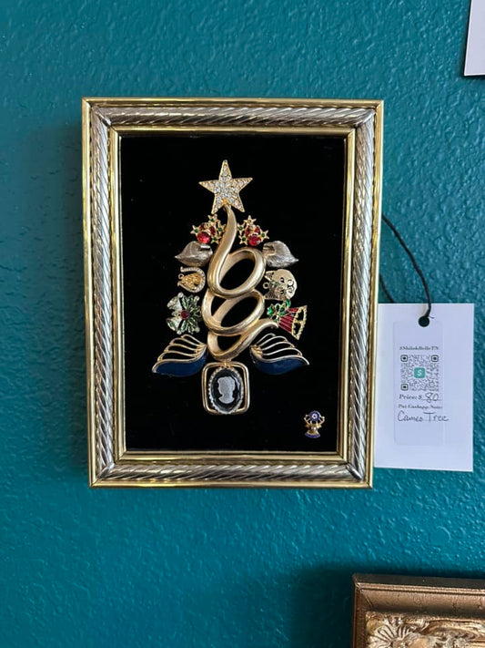 Christmas tree art piece made of vintage jewelry on velvet, framed in a silver and golden frame