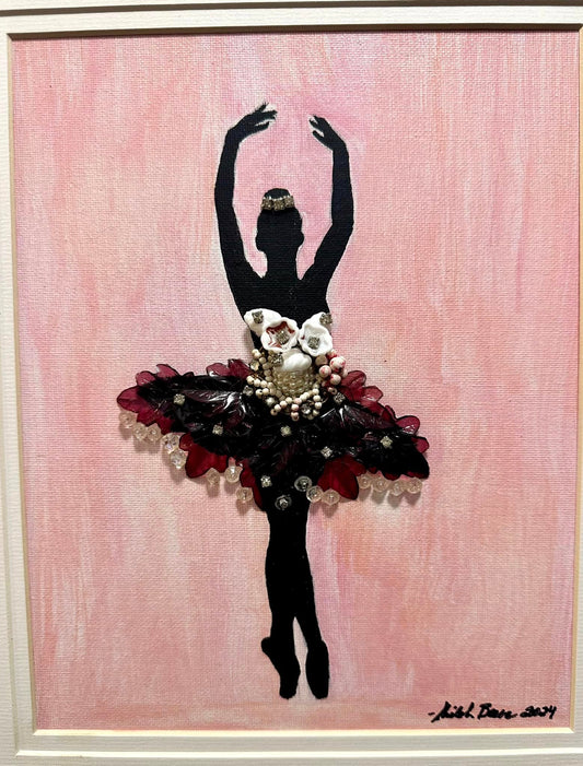Artistic depiction of a ballerina silhouette with floral details made from vintage jewelry on a pink background in a golden frame